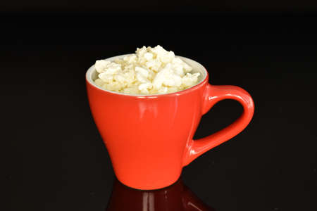 Fresh tasty, nutritious cottage cheese, close-up, on a black background.の写真素材