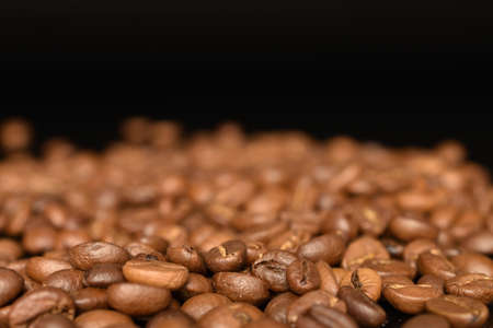 Fragrant roasted coffee grains, close-up, on a black backgroundの写真素材