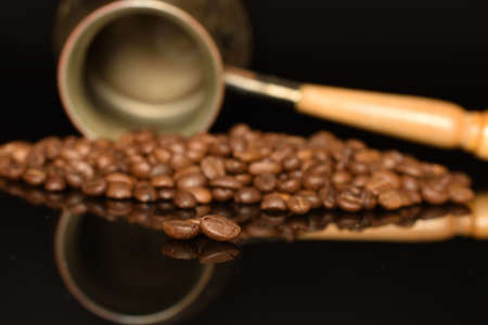 Fragrant roasted coffee grains, close-up, on a black backgroundの写真素材