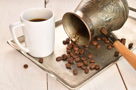 Fragrant roasted coffee grains, close-up, on a painted wooden table.の写真素材