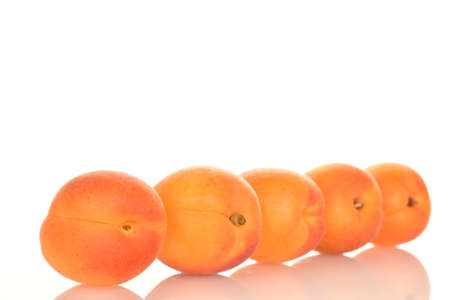 Bright yellow fresh, organic, ripe apricots, close-up, on a white background.の写真素材