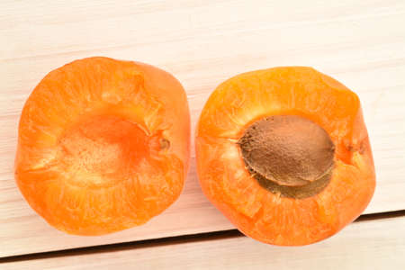 Bright yellow fresh, organic, ripe apricots, close-up, on a painted wooden table.の写真素材
