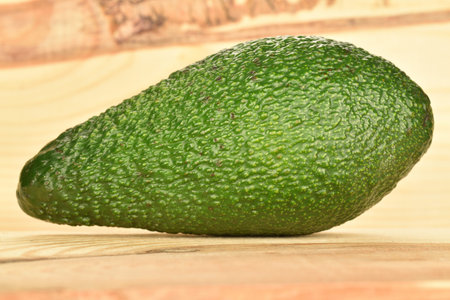 Juicy, ripe, organic avocados, macro, on a background of natural wood.