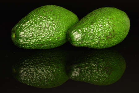 Juicy, ripe, organic avocados, close-up, on a black background.の写真素材