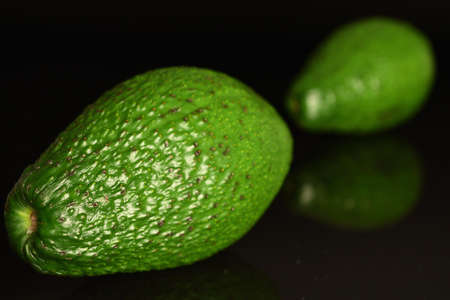 Juicy, ripe, organic avocados, close-up, on a black background.の写真素材
