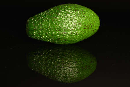 Juicy, ripe, organic avocados, close-up, on a black background.の写真素材