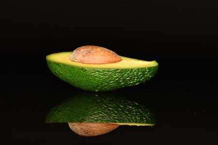 Juicy, ripe, organic avocados, close-up, on a black background.の写真素材