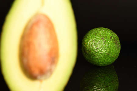 Juicy, ripe, organic avocados, close-up, on a black background.の写真素材