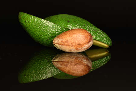 Juicy, ripe, organic avocados, close-up, on a black background.の写真素材