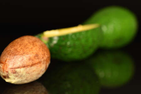 Juicy, ripe, organic avocados, close-up, on a black background.の写真素材