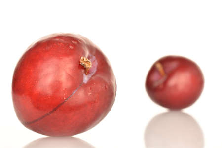 Juicy, tasty, organic red plum, close-up, on a white background.の写真素材