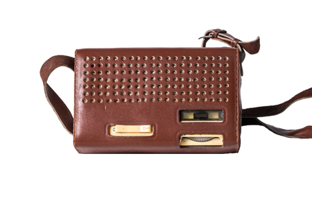 Old transistor radio in a leather case isolated on whiteの写真素材