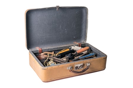 Open retro suitcase full of old working tools isolated on a white backgroundの写真素材