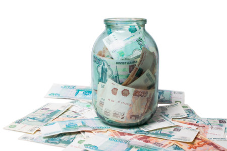 One and  five thousand roubles banknotes in the glass jar isolated on white background