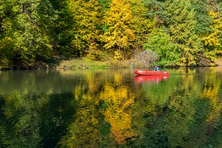 MOSCOW, RUSSIA - OCTOBER 7, 2018: Autumn in Tsaritsino park and reserve. A park keeper sailing inflatable boat.のeditorial素材
