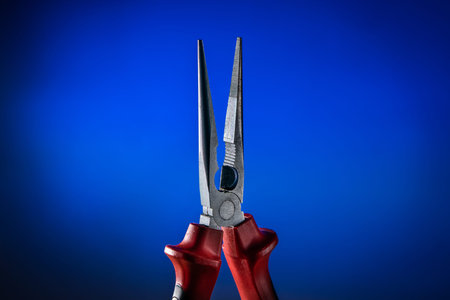 Needle Nose (Long Nose) Pliers on blue backgroundの写真素材