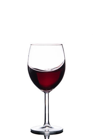 Wine in tulip shaped wine glass isolated on white backgroundの写真素材