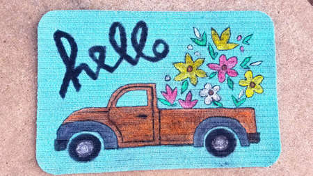 A rug with the words hello. Cute rug with the word hello written in script at the entrance of a home welcoming guestsの写真素材
