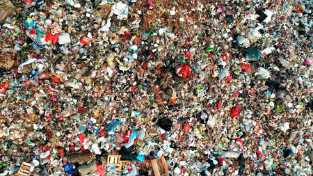 Man on the mountain of garbage. Photo taken from above. Mountain of garbage. Save the planet.