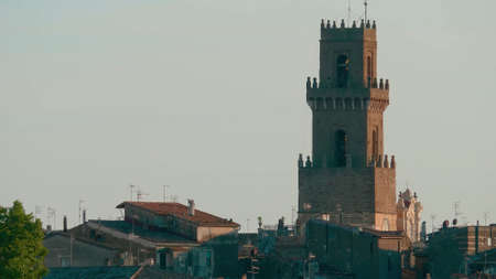Tuscany, Italy. Old tower in Italy and roofs of houses made of tiles.の写真素材