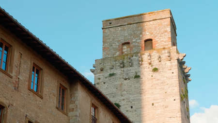 Tuscany, Italy. The old tower. Photographed from bottom to top. Against the background of blue sky.の写真素材