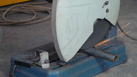 circular saw cuts metal, sparks in all directionsの写真素材