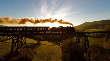 Train on the bridge like in Harry Potor. Old Steam Train on old Bridge over.の写真素材