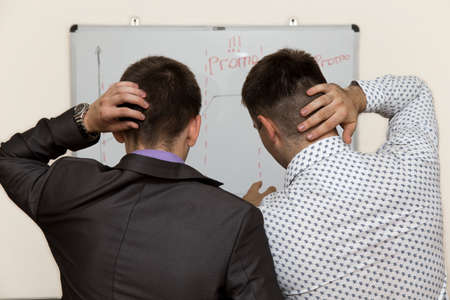 Two male corporate workers realise that they did a mistakeの写真素材