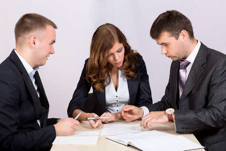 Business people discuss deal negotationing dicsussion offer paperwork smart casual dress code deskの写真素材