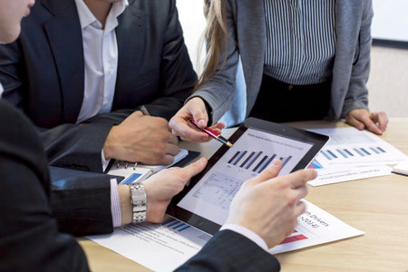 Business meeting close up image Group of people having discussion about the corporate data. Female manager explains the chart to her male counterpartの写真素材