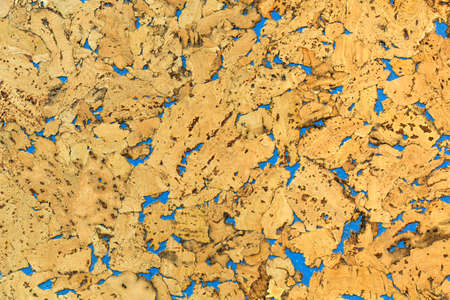 Bright brown orange cork panel Surface covered with cork shape with blue gapsの写真素材