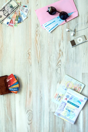 Travel background with essential tourist items on wooden desk passport international with entry...