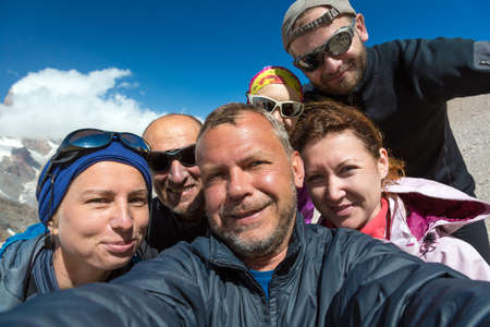 Faces of Five People Men and Women Young and Elder Expressing Fun and Joy Blue Sky Backgroundの写真素材