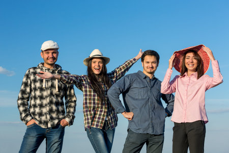 Four People Men and Women Together on Blue Sky Background Casual Jeans Style Dress Hands Gesturing...