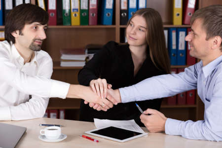 Group of young Business People shaking Handsの写真素材