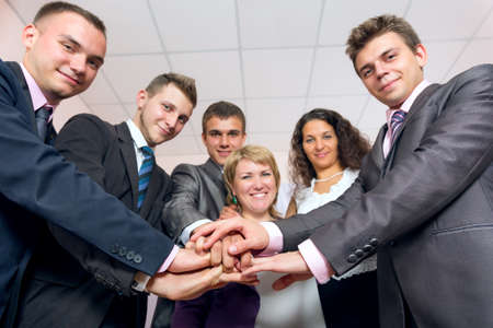 Happy Business Team uniting Hands and smilingの写真素材