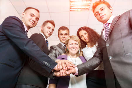 Happy Business Team uniting Hands and smilingの写真素材