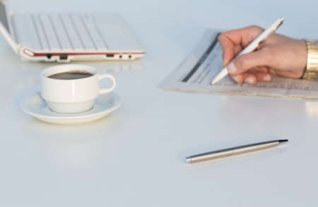Angle View of Work Place with Laptop Color Pencils and Business Newspaperの写真素材