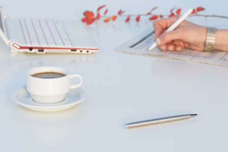 White working Desk with Business Items and red Flowerの写真素材