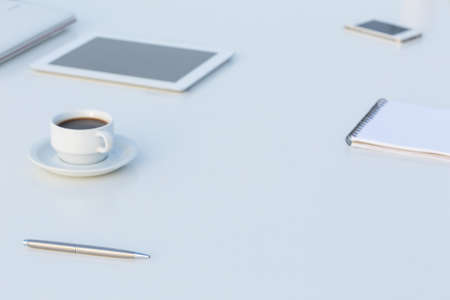 Side View of White Table with Electronics and Stationaryの写真素材
