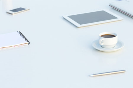 Side View of White Table with Electronics and Stationaryの写真素材