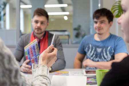 Business Discussion young People in casual Clothing Man pointingの写真素材