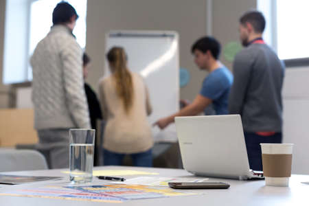 People working at Flip chart business items on Tableの写真素材