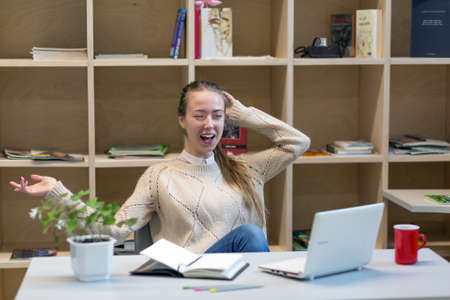 Happy young Woman getting good News email laughingの写真素材