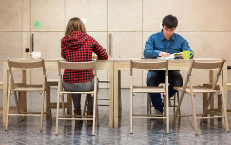 Two Students sitting at Campus Club Areaの写真素材