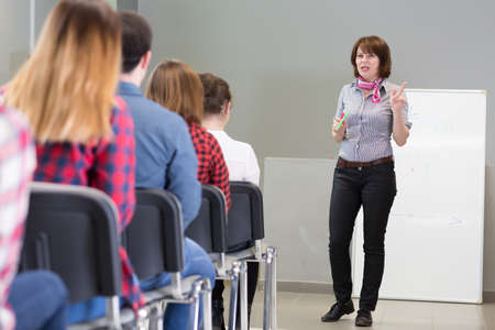 Female Lecturer delivering Presentation to Audienceの写真素材