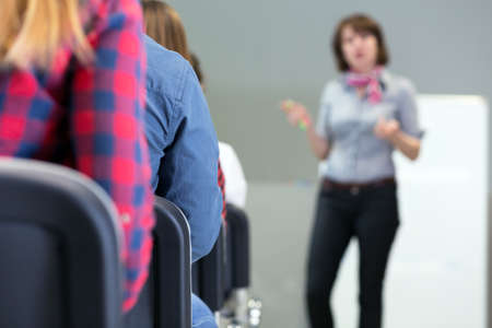 Female Lecturer delivering Presentation to Audienceの写真素材