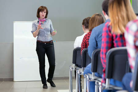 Female Lecturer delivering Presentation to Audienceの写真素材