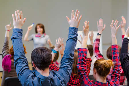 Active Students raising Arms up ready to answer Teachers Questionの写真素材