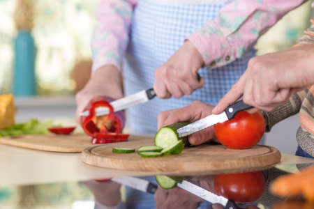 Family cooking Salad togetherの写真素材